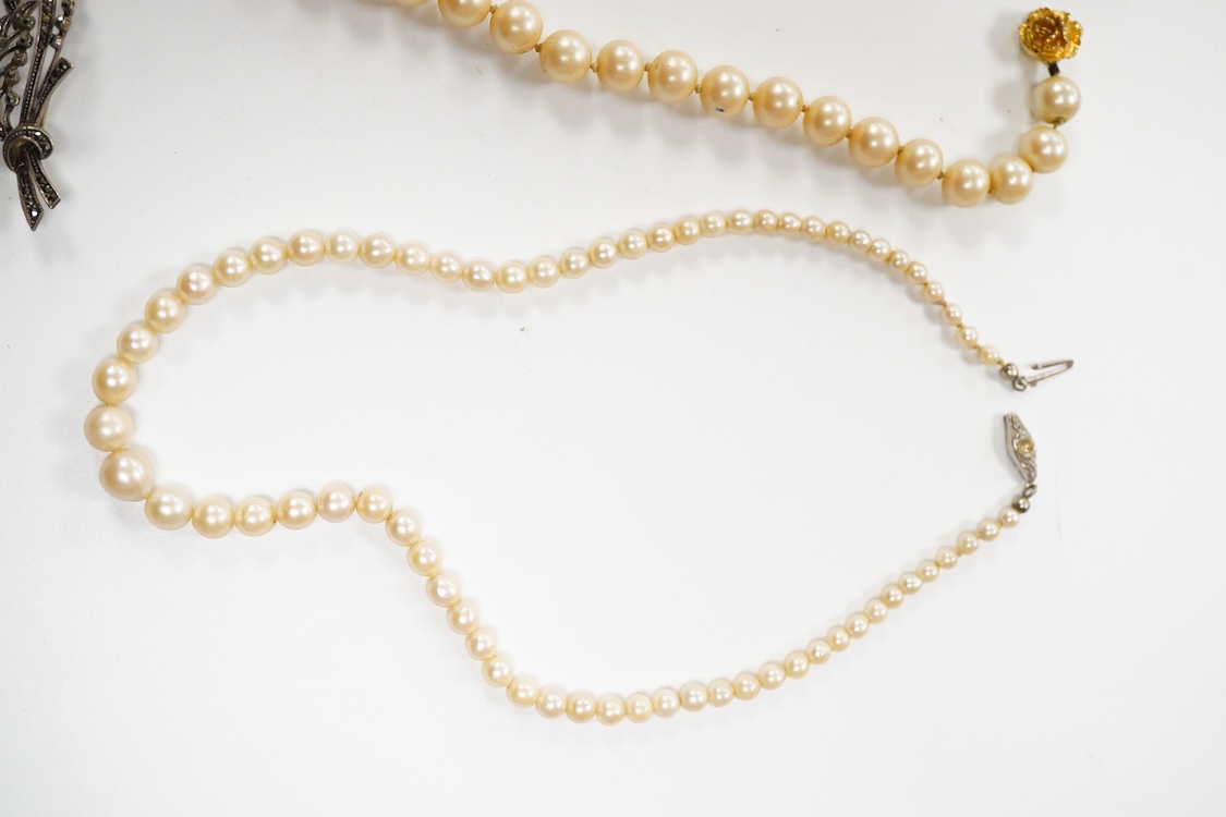 Two single strand graduated cultured pearl necklaces, one with a single stone rose cut diamond set 9ct white metal clasp, 42cm, together with a simulated pearl necklace and three assorted costume brooches.